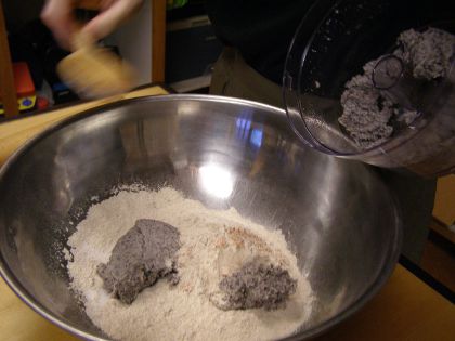 Some mashed beans have been dumped into the bowl dry ingredients.