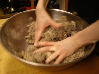 A blurry image of my two hands stirring the ingredients together.