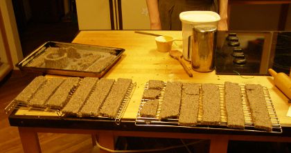 Two racks covered in biscuit strips, with some of the other kitchen stuff nearby.