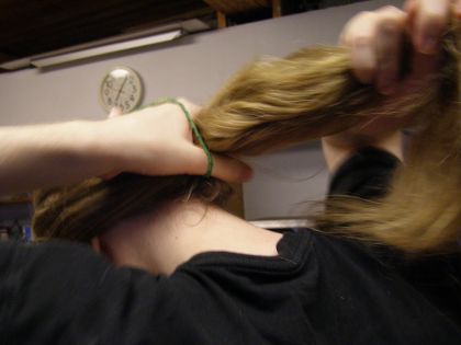 The back of my head. I'm using a hair tie to tie my hair back.