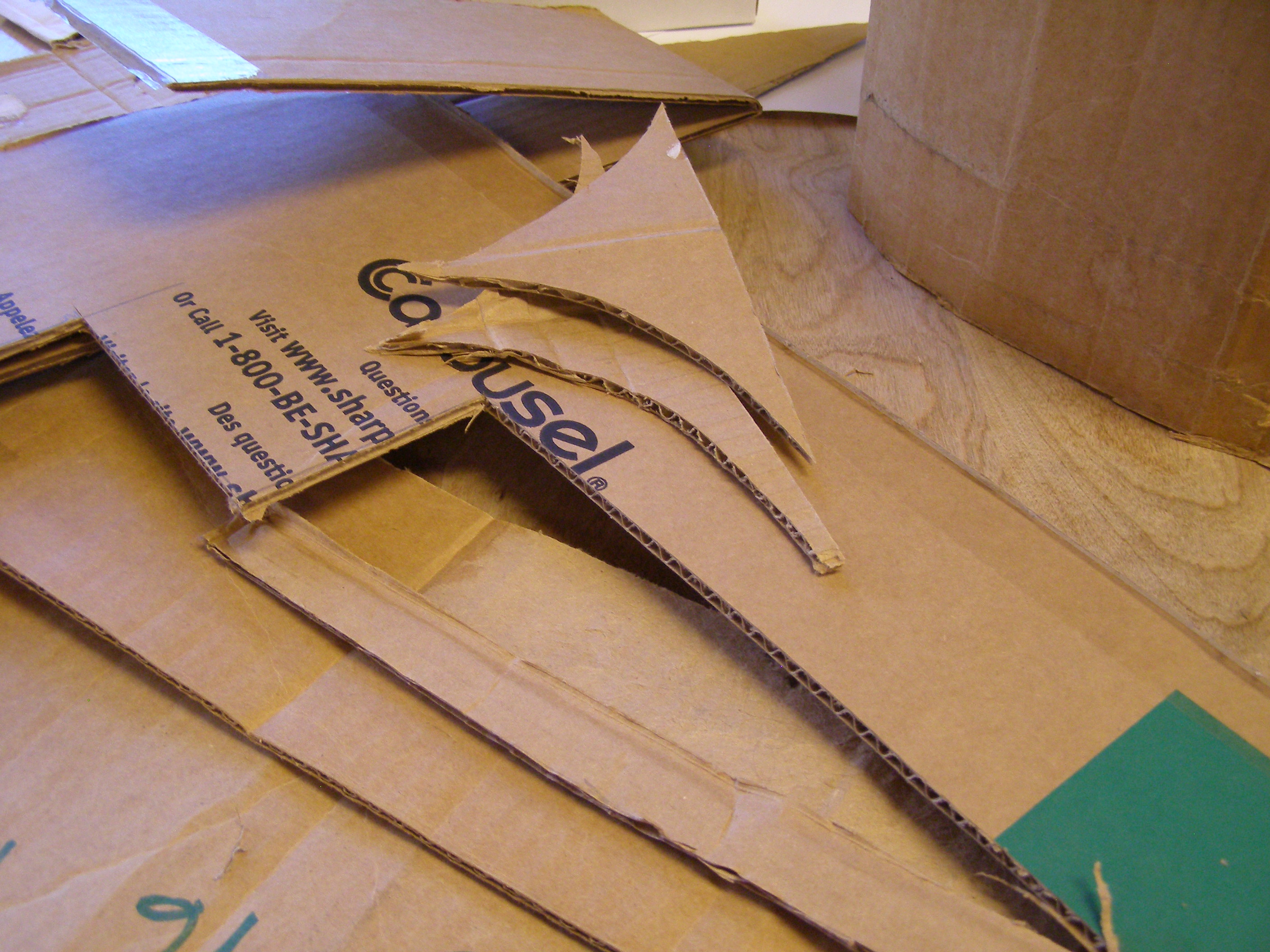 [Photo: a pile of corrugated cardboard in various shapes.]